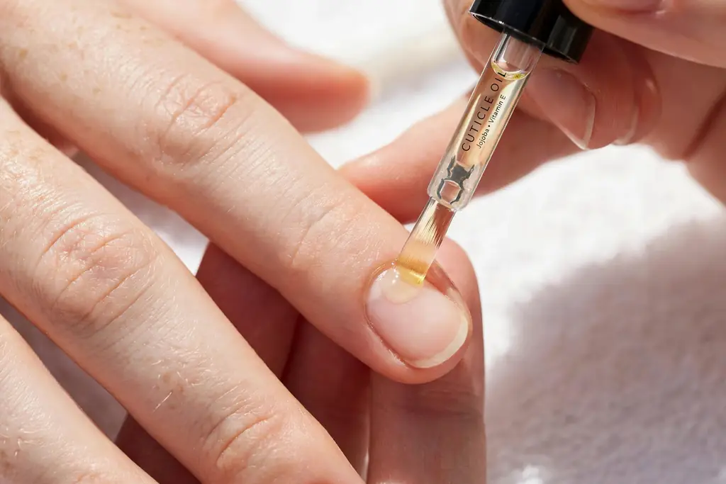 Applying cuticle oil as aftercare
