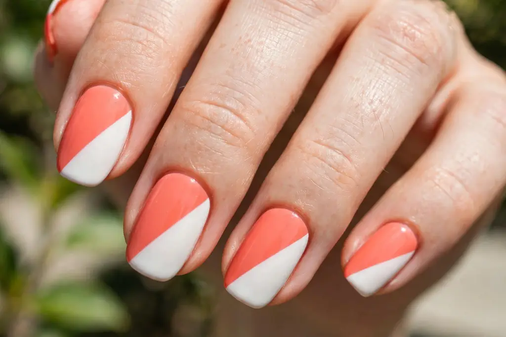 Two-tone color block design split diagonally between coral and white
