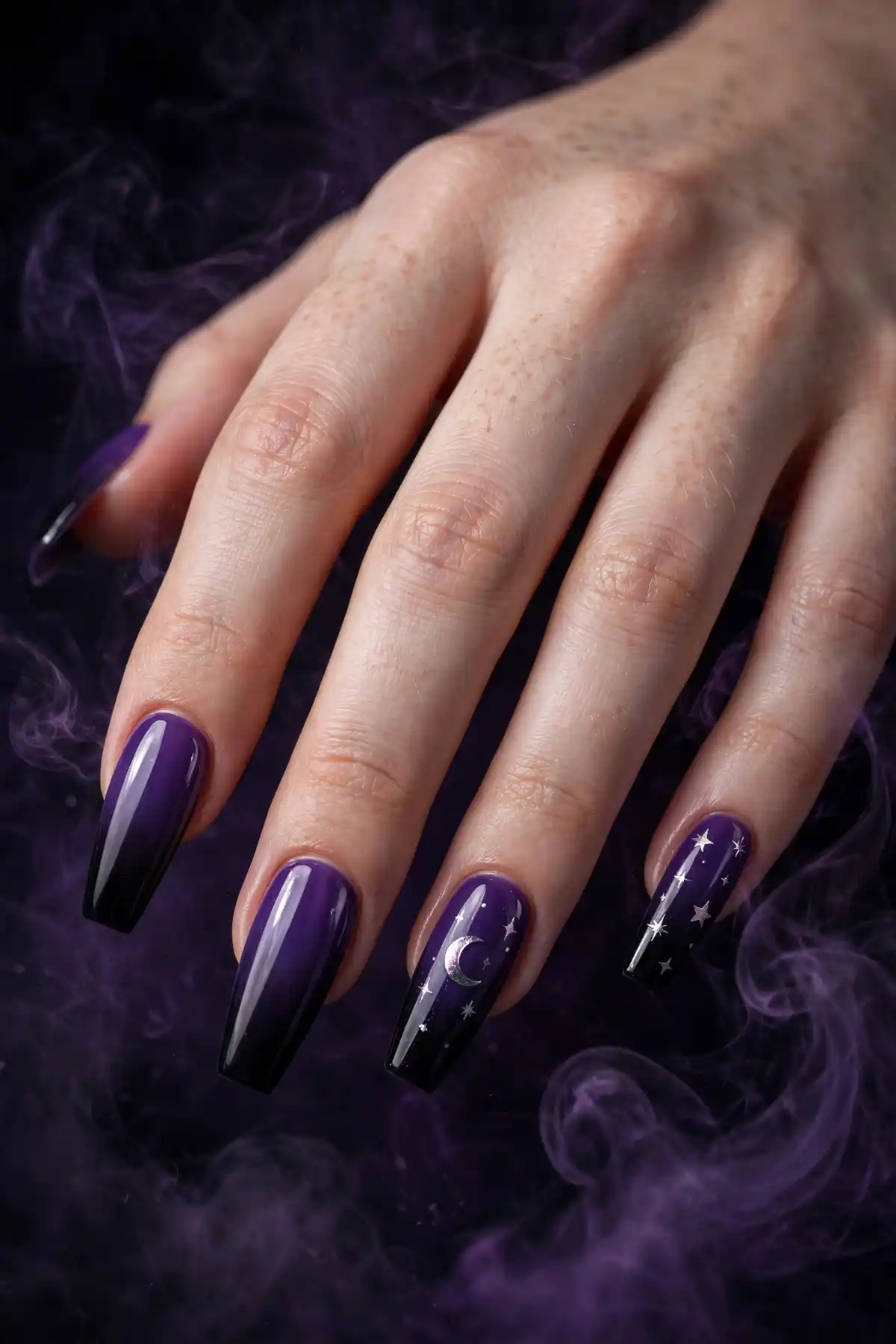 Witchy purple and black Halloween nails with moon decals