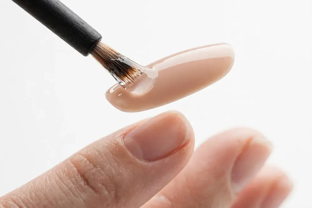 Applying brush-on glue to press on nail tips