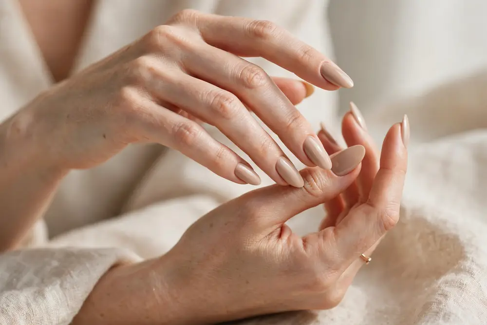 Elegant nude press on nails on graceful hands