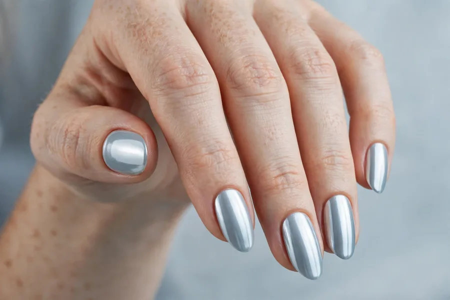 Mirror-shine icy chrome winter nail designs on fair hands